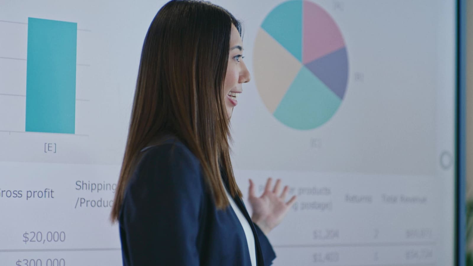'A woman giving a presentation in front of a screen with a smile.'