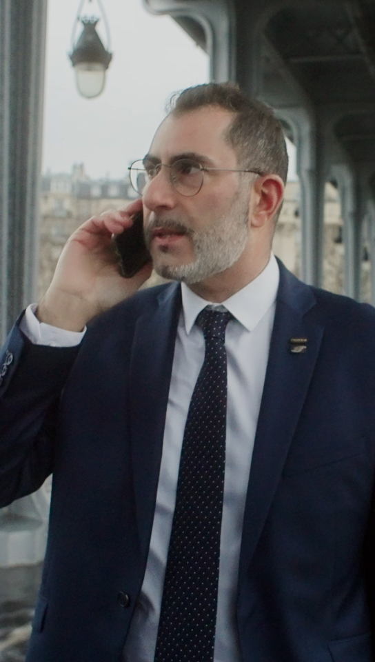 Christophe talking on his cell phone