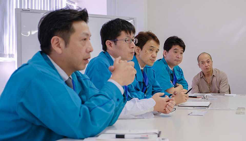 [photo] From left: Onoki (Product planner), Takeda (Mechanical designer), Toyama (optical designer), Sasaki (Optical engineer), Sakai (Designer) during a Fujifilm presentation