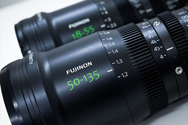 [photo] Close-up of Fujinon 50-135mm and 18-55mm lenses on a white table