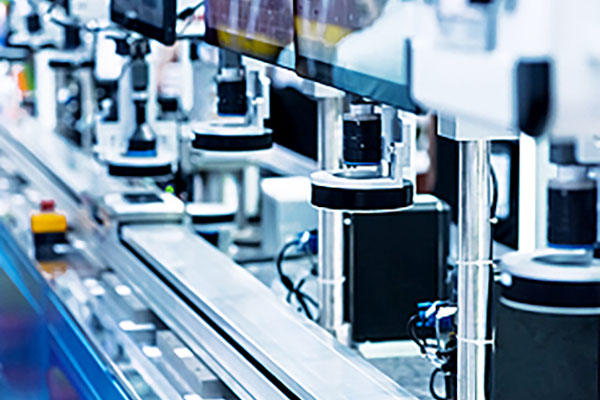 [photo] A close-up view of a lens inspection assembly line