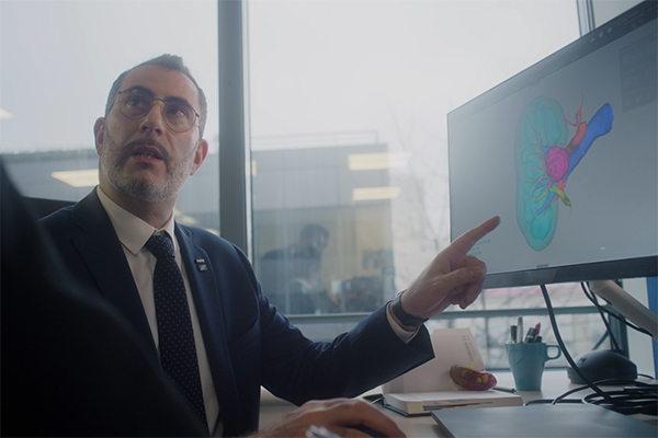 Man pointing at monitor in office
