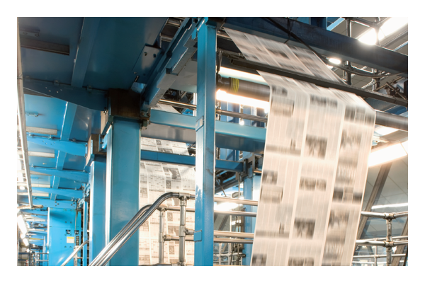 Newspaper flowing through printing machine