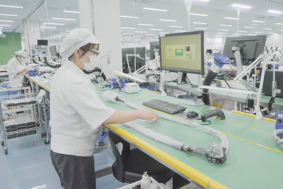 Woman working with endoscope on table