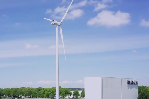 Wind power generation and building with Fujifilm logo